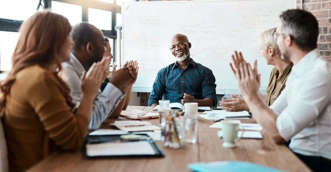 Business leaders discussing strategy around a conference table.